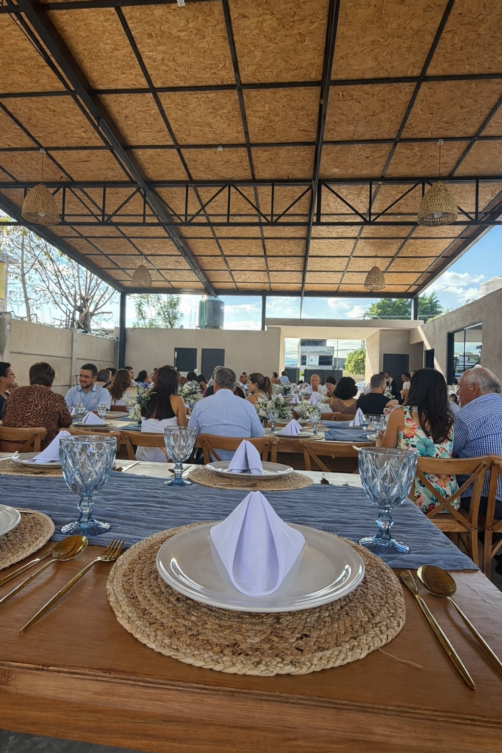 Vista del salón techado con mesas montadas y invitados; montaje para eventos familiares en Diversitopia.